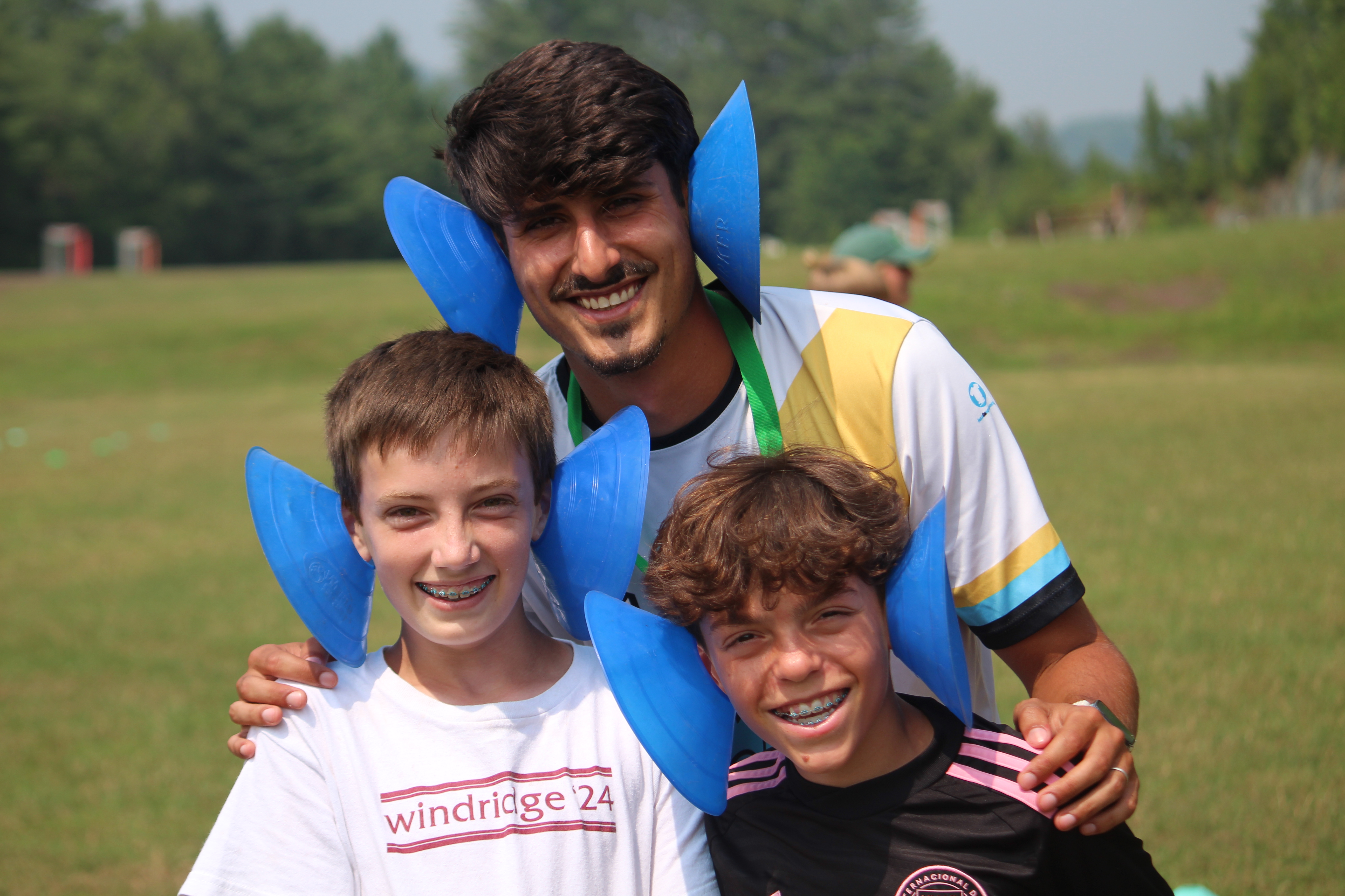 A Windridge soccer counselor with two campers
